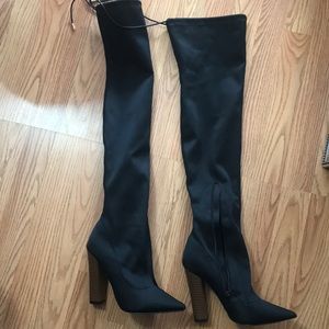 Thigh high black boots.